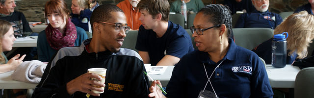 Two Vista members talking at orientation